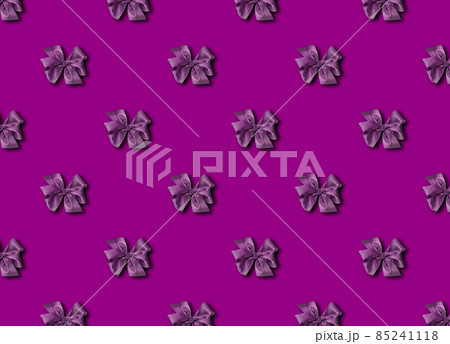 A bow for decorating gifts, painted in purple Velvet Violet. Beautifully tied bow. Photo of a gift package with a seamless pattern. A bow for decorating gifts, painted in purple Velvet Violet. Beautifully tied bow. Photo of a gift package with a seamless pattern. 85241118