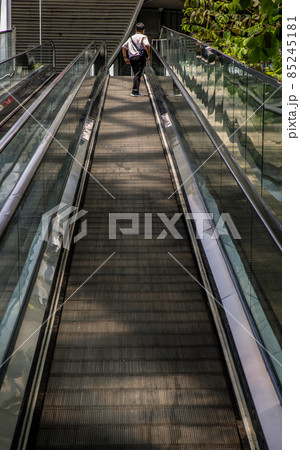 Modern escalator staircase with people for facilities in a contemporary building. Modern escalator staircase with people for facilities in a contemporary building. 85245181