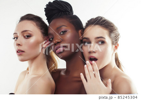three different nation woman: african-american, caucasian together isolated on white background happy smiling, diverse type on skin, lifestyle real people concept three different nation woman: african-american, caucasian together isolated on white background happy smiling, diverse type on skin, lifestyle real people concept 85245304
