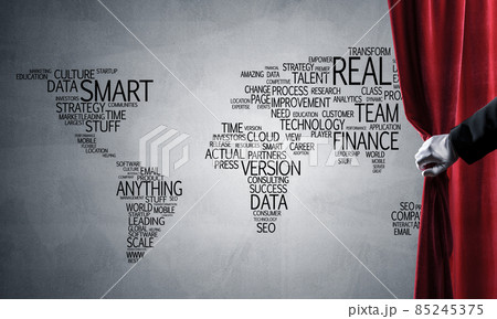 World map behind drapery curtain and hand opening it World map behind drapery curtain and hand opening it 85245375