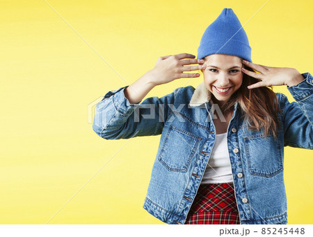 lifestyle people concept: pretty young school teenage girl having fun happy smiling on yellow background lifestyle people concept: pretty young school teenage girl having fun happy smiling on yellow background 85245448