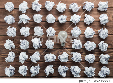 Ideological concept with wastepaper light bulb on wooden table Ideological concept with wastepaper light bulb on wooden table 85245551