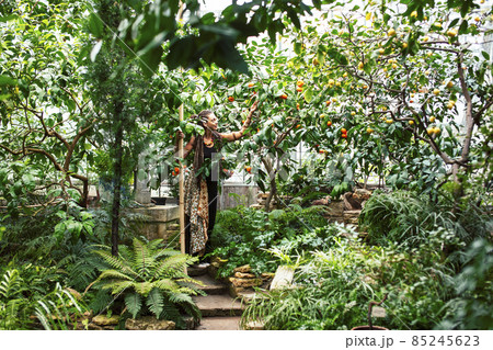Young cute smiling woman in park with oranges, lifestyle concept green spring Young cute smiling woman in park with oranges, lifestyle concept green spring 85245623