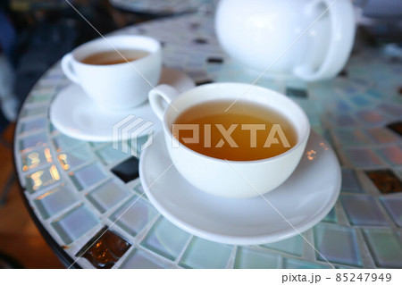 hot tea , tea cup and kettle 85247949