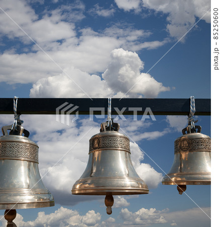 Orthodox bells closeup against the sky with clouds.  New Jerusalem in town Istra, surroundings of Moscow, Russia. 85250600