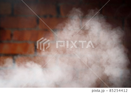 dense smoke against brick wall background 85254412