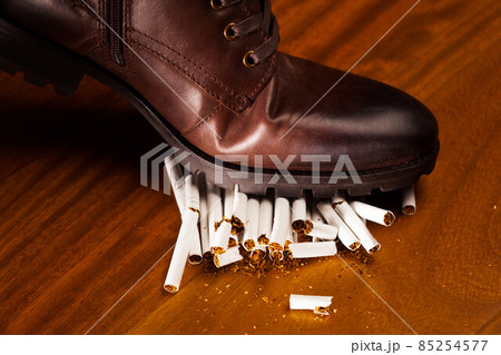 shoes trampling down on cigarettes shoes trampling down on cigarettes 85254577