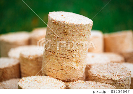 wooden pellets on green grass background wooden pellets on green grass background 85254647