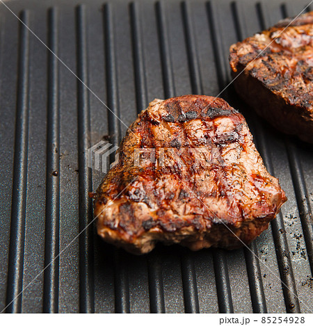 fresh fried steak on a grill pan fresh fried steak on a grill pan 85254928