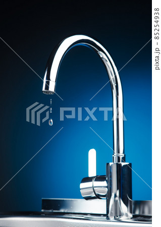 mixer tap with water drops, blue background mixer tap with water drops, blue background 85254938