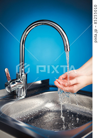 mixer tap with water and washing hands 85255010