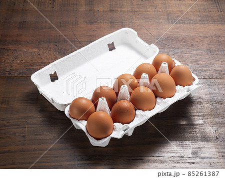 紙製のパックに入った赤い卵 85261387