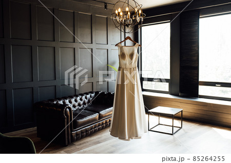 White dress of the bride before the wedding. It is located in a dark room 85264255