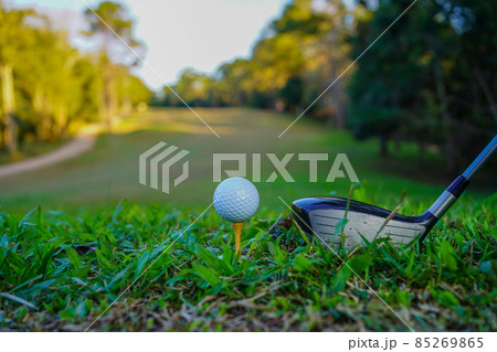 Golf clubs and golf balls on a green lawn in a beautiful golf course with morning sunshine. golf ball on green grass ready to hit on golf course background 85269865