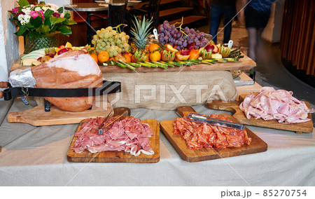 Colored buffet with seasonal fresh fruits and different kind of Ham 85270754