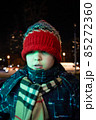 Neon green light. The boy looks into the distance on the background of the night city. High quality photo 85272360
