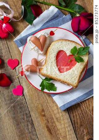 Breakfast for valentine's day or mother's day. Toast with salmon and cheese with the inscription that I love you, on a rustic table. 85273774