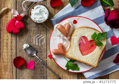 Breakfast for valentine's day or mother's day. Toast with salmon and cheese with the inscription that I love you, on a rustic table. 85273775