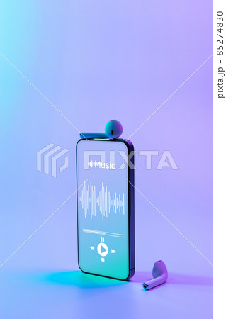 Music banner. Mobile smartphone screen with music application, sound headphones. Audio voice with radio beats on neon gradient background. Broadcast media music banner with copy space. Music banner. Mobile smartphone screen with music application, sound headphones. Audio voice with radio beats on neon gradient background. Broadcast media music banner with copy space. 85274830