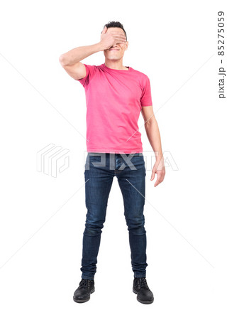 Man covering eyes with hand in studio 85275059