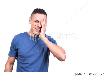 Man with hand on face with expression of pain Man with hand on face with expression of pain 85275573