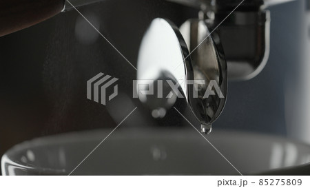 rinsing coffee machine with double spout portafilter closeup rinsing coffee machine with double spout portafilter closeup 85275809