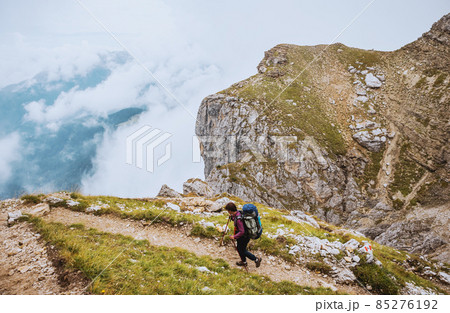 Sporty Young woman on mountain trail Dolomites Mountains, Italy 85276192