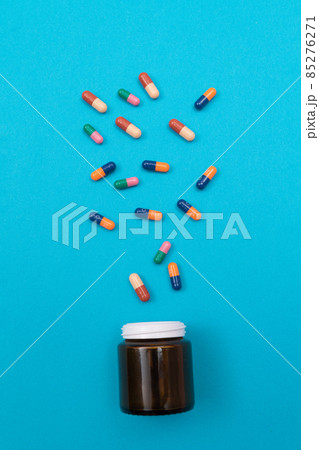 Pharmaceutical Industry and Medicinal Products - Colored Pills on Blue Table Pharmaceutical Industry and Medicinal Products - Colored Pills on Blue Table 85276271