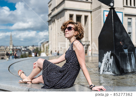 Portrait of a twnety year old redhaired girl with the city in the background 85277362