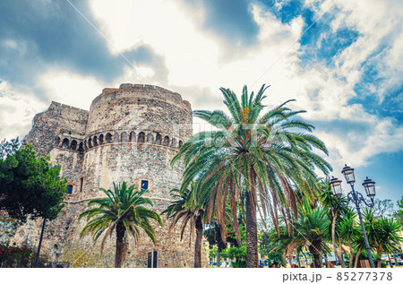 Aragonese Castle Castello Aragonese stone medieval buildings and palm trees in Piazza castello square in Reggio Calabria Aragonese Castle Castello Aragonese stone medieval buildings and palm trees in Piazza castello square in Reggio Calabria 85277378