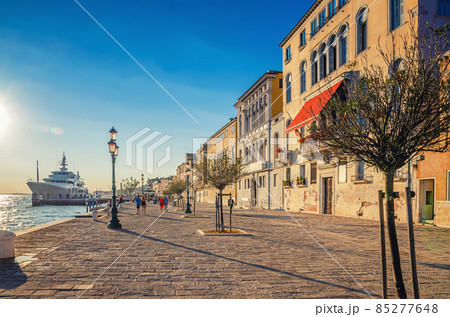 People tourists are walking down embankment promenade Fondamenta Zattere People tourists are walking down embankment promenade Fondamenta Zattere 85277648