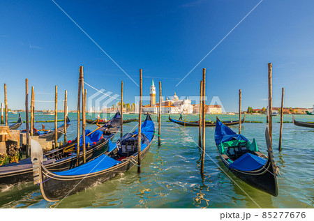 Gondolas moored docked on water in Venice 85277676
