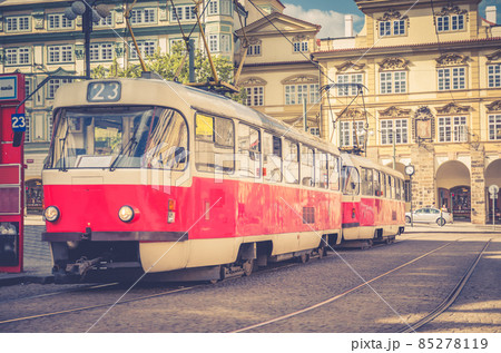 Typical old retro vintage tram on tracks near tram stop in the streets of Prague 85278119