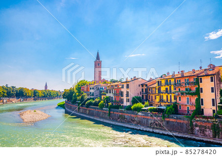Verona cityscape with buildings on embankment of Adige river, bell tower Campanile 85278420