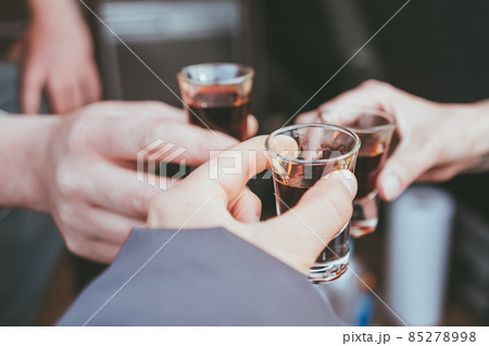 Three friends toast to health and drink liquor Three friends toast to health and drink liquor 85278998