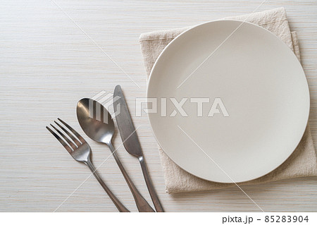empty plate or dish with knife, fork and spoon empty plate or dish with knife, fork and spoon 85283904