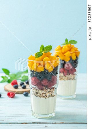 homemade mango, raspberry and blueberry with yogurt and granola homemade mango, raspberry and blueberry with yogurt and granola 85283967