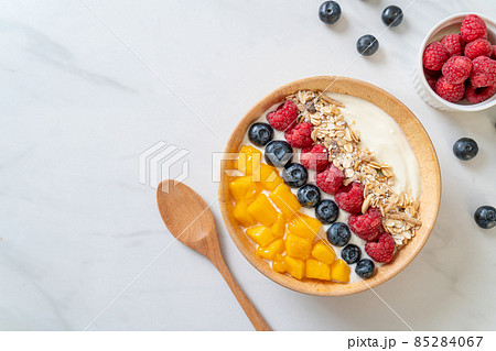homemade yogurt bowl with raspberry, blueberry, mango and granola 85284067