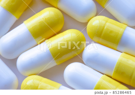 A macro close up to white and yellow capsules 85286465