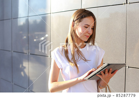 Woman browsing tablet in business center Woman browsing tablet in business center 85287779