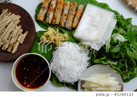 Vietnamese homemade vegan food, fried spring rolls with bun herbal leaf and rice paper Vietnamese homemade vegan food, fried spring rolls with bun herbal leaf and rice paper 85289132
