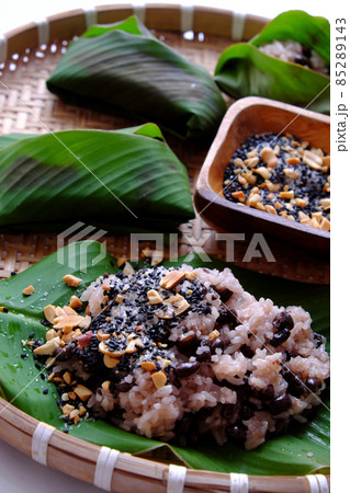 Vietnamese homemade black bean sticky rice with sesame salt for cheap and quick breakfast in green leaf Vietnamese homemade black bean sticky rice with sesame salt for cheap and quick breakfast in green leaf 85289143