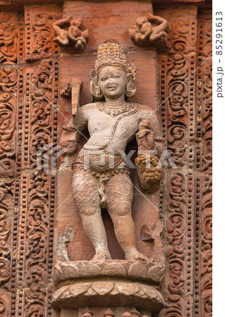 Sculpture of Agnidev the God of fire on Rajarani Temple. 11th century Odisha style temple constructed dull red and yellow sandstone, Bhubaneswar, Odisha, India. Sculpture of Agnidev the God of fire on Rajarani Temple. 11th century Odisha style temple constructed dull red and yellow sandstone, Bhubaneswar, Odisha, India. 85291613