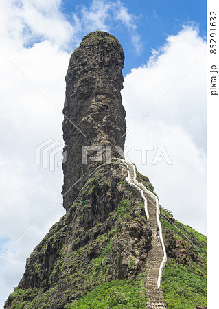View of stairs and Tungi hill rock, Mangi Tungi, Nashik, Maharashtra, India. Prominent twin-pinnacled peak with plateau in between. View of stairs and Tungi hill rock, Mangi Tungi, Nashik, Maharashtra, India. Prominent twin-pinnacled peak with plateau in between. 85291632