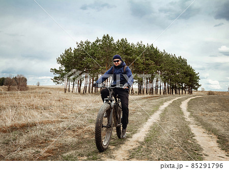 A man rides an electric bike with thick wheels. Sports hobby. 85291796