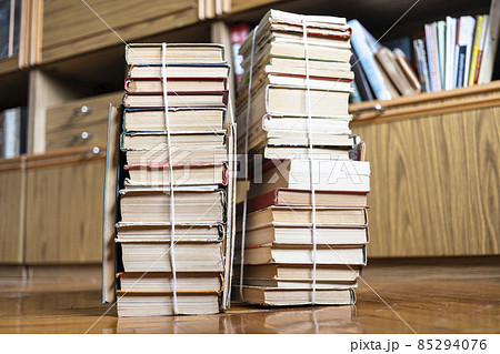 two stacks of old books tied with twine on floor two stacks of old books tied with twine on floor 85294076