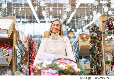 Christmas decoration shopping. Caucasian woman choose new year decor in shopping mall 85295191