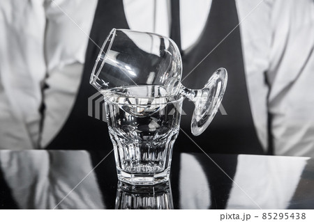 The process of preparing an alcoholic hot cocktail with Italian liqueur of a drink in sambuca glass The process of preparing an alcoholic hot cocktail with Italian liqueur of a drink in sambuca glass 85295438