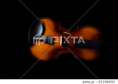 Part of the violin on a dark background. Part of the violin on a dark background. 85296693