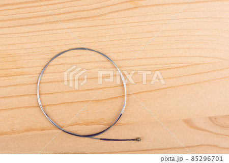 Top view of a violin string on a wooden background. Top view of a violin string on a wooden background. 85296701